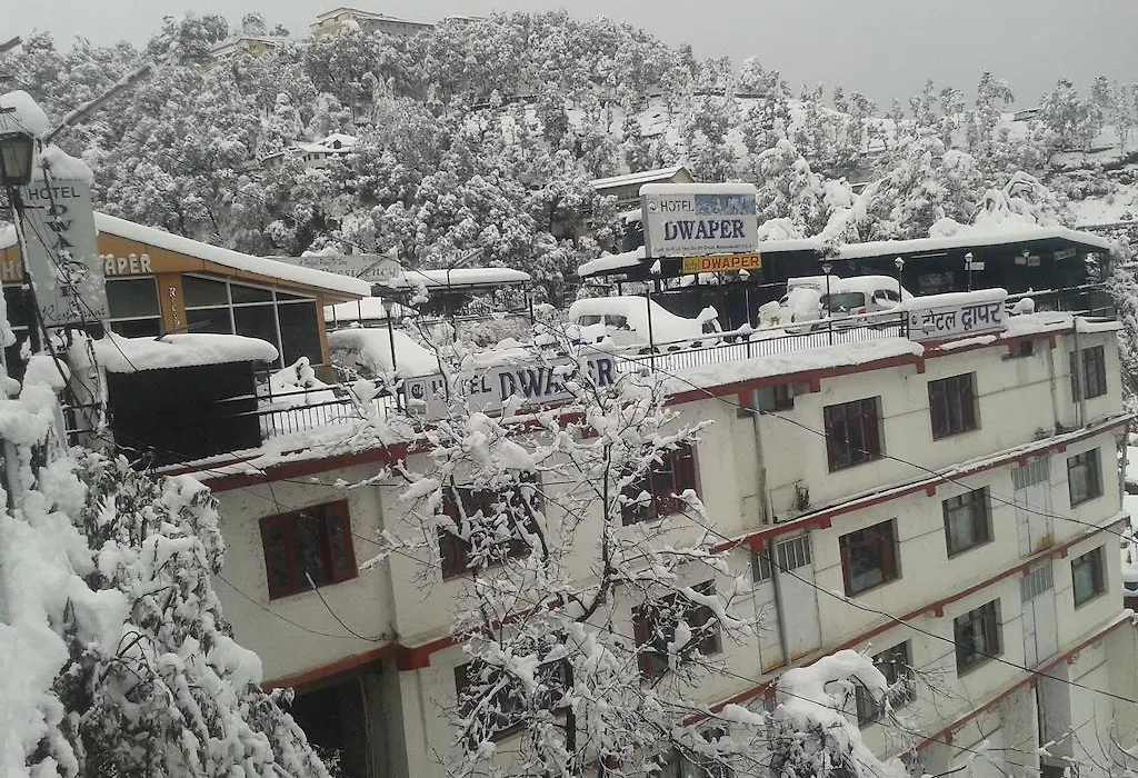 Snowfall at Hotel Dwaper in Mussoorie, with snowflakes gracefully descending amidst the scenic beauty of the mountains.