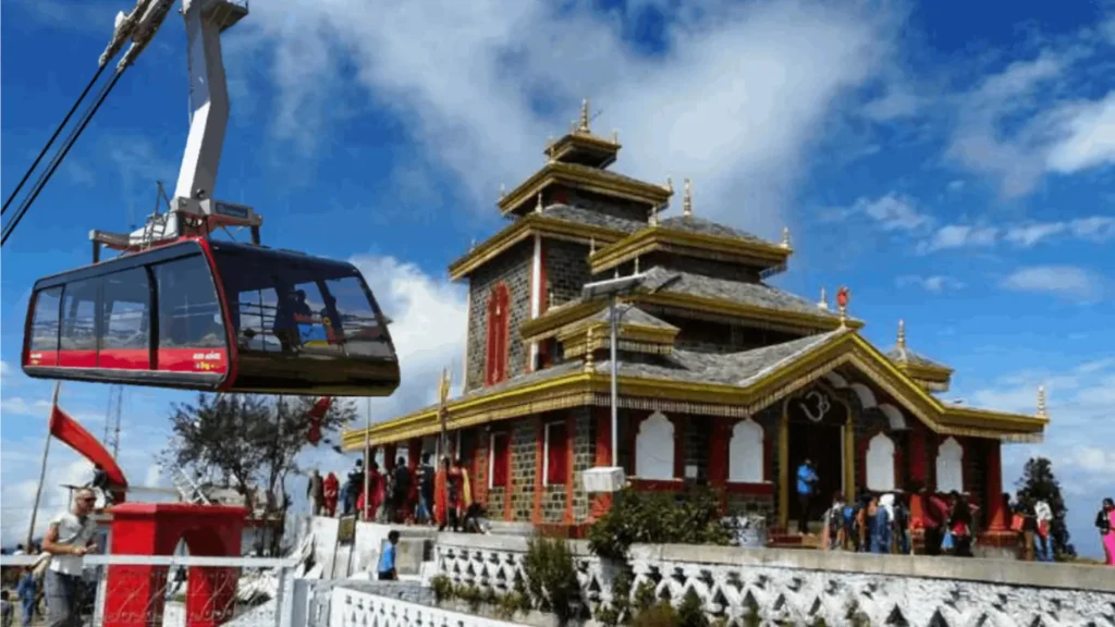 A colorful Hindu temple dedicated to Surkanda Devi, perched on a hilltop in Mussoorie, India.